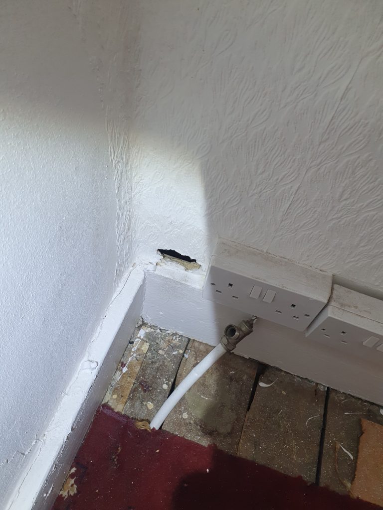 Hole in plasterboard in bedroom in East Sussex Hole in plasterboard